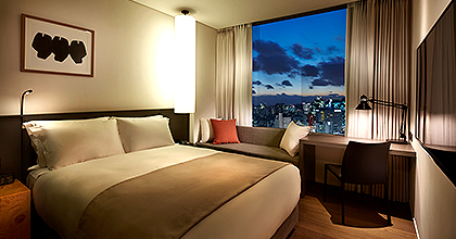 마포 스탠다드 객실 이미지로, 침구의 오른쪽에 샤워실이 보인다. 샤워실은 미닫이 형태의 가림막으로 가려질 수 있다.